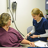 Woman giving blood transfusion